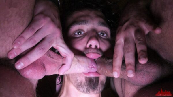 young guy takes two cocks in his mouth at the same time